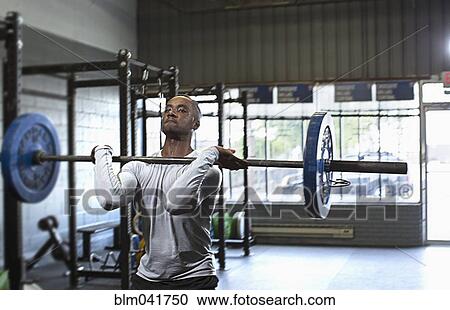 Black athlete lifting weights in gym View Large Photo Image Stock Image - Black athlete lifting weights in gym. Fotosearch