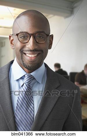 Stock Photograph - Black businessman smiling in office. Fotosearch