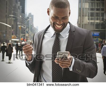 Black businessman using cell phone outdoors View Large Photo Image Stock Image - Black businessman using cell phone outdoors. Fotosearch