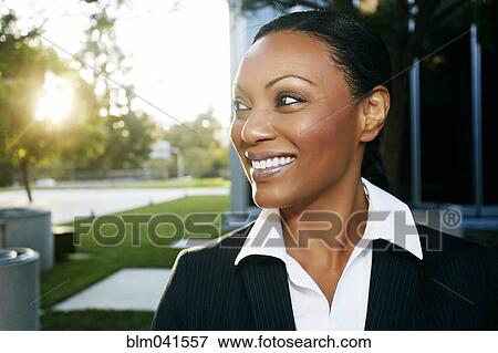 Stock Photo - Black businesswoman smiling outdoors. Fotosearch