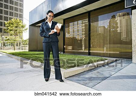 Black businesswoman using digital tablet outdoors View Large Photo Image Stock Image - Black businesswoman using digital tablet outdoors. Fotosearch