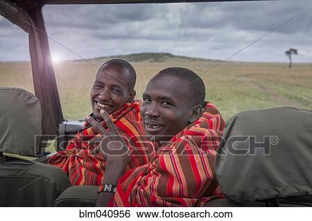 Stock Photograph - Black men smiling in car in remote field. Fotosearch