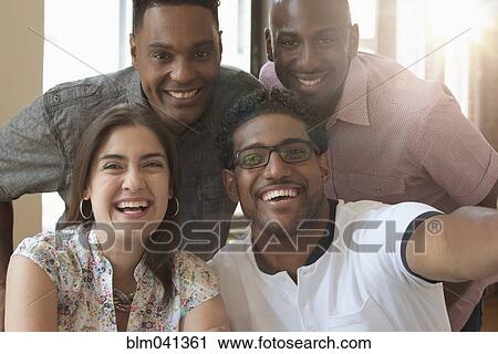 Stock Image - Business people smiling in office. Fotosearch