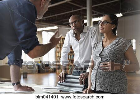 Stock Image - Business people talking in office. Fotosearch