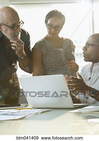 Stock Photo - Business people talking in office. Fotosearch