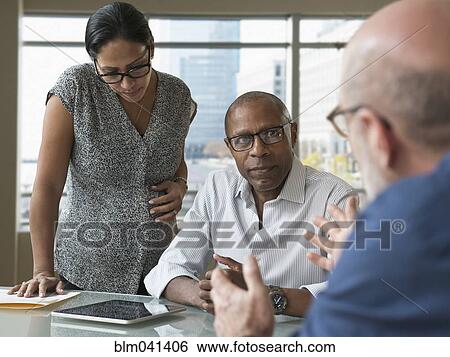 Stock Photograph - Business people talking in office. Fotosearch