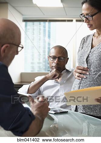 Business people using digital tablet in office View Large Photo Image Stock Image - Business people using digital tablet in office. Fotosearch