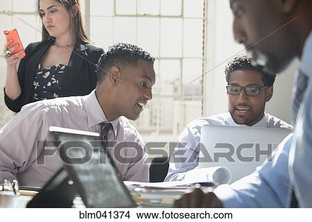 Business people using technology in office View Large Photo Image Picture - Business people using technology in office. Fotosearch