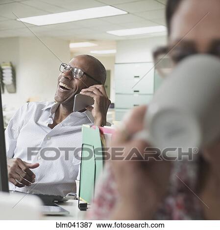 Stock Photo - Business people working in office. Fotosearch