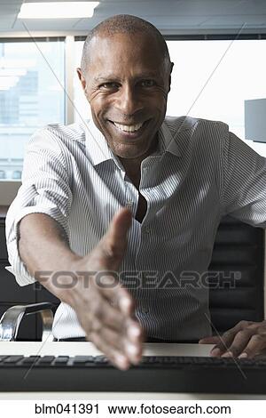 Stock Image - Businessman offering handshake. Fotosearch