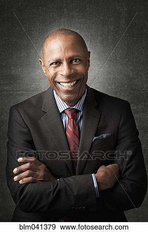 Businessman smiling with arms crossed View Large Photo Image Stock Photo - Businessman smiling with arms crossed. Fotosearch