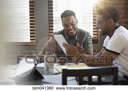 Businessman using digital tablet in office View Large Photo Image Stock Image - Businessman using digital tablet in office. Fotosearch
