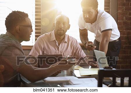 Businessmen talking in office meeting View Large Photo Image Stock Image - Businessmen talking in office meeting. Fotosearch