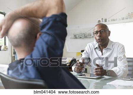 Businessmen talking in office View Large Photo Image Picture - Businessmen talking in office. Fotosearch