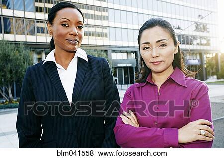 Stock Photo - Businesswomen standing outdoors. Fotosearch