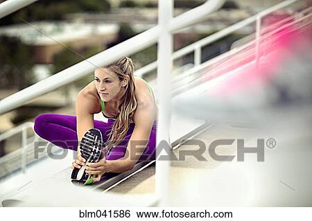 Caucasian athlete stretching on bleachers View Large Photo Image Stock Photograph - Caucasian athlete stretching on bleachers. Fotosearch