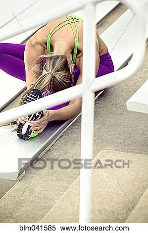 Caucasian athlete stretching on bleachers View Large Photo Image Stock Photography - Caucasian athlete stretching on bleachers. Fotosearch