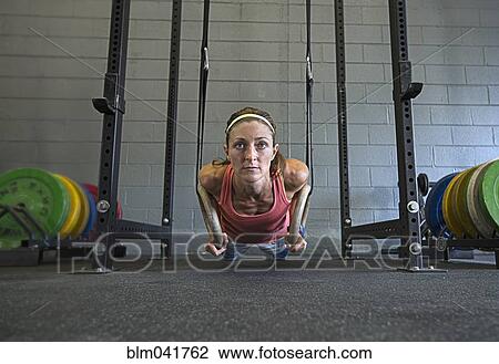 Caucasian athlete using rings in gym View Large Photo Image Stock Image - Caucasian athlete using rings in gym. Fotosearch