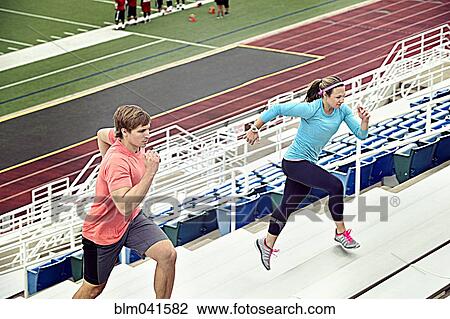 Caucasian athletes running up bleachers View Large Photo Image Stock Image - Caucasian athletes running up bleachers. Fotosearch