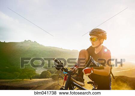 Stock Photo - Caucasian boy riding dirt bike outdoors. Fotosearch