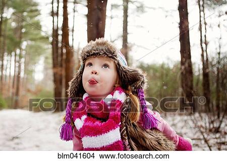 Caucasian girl catching snow on tongue View Large Photo Image Picture - Caucasian girl catching snow on tongue. Fotosearch