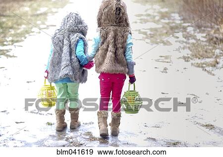 Caucasian girls holding hands in snow View Large Photo Image Stock Photo - Caucasian girls holding hands in snow. Fotosearch
