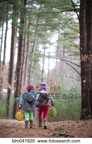 Caucasian girls walking in forest View Large Photo Image Stock Image - Caucasian girls walking in forest. Fotosearch