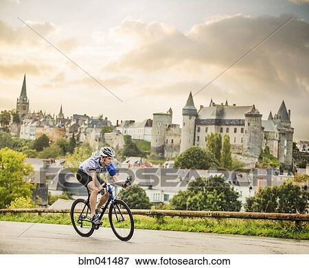 Stock Photo - Caucasian man cycling outdoors. Fotosearch