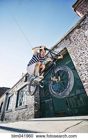 Caucasian man jumping on BMX bike View Large Photo Image Stock Image - Caucasian man jumping on BMX bike. Fotosearch
