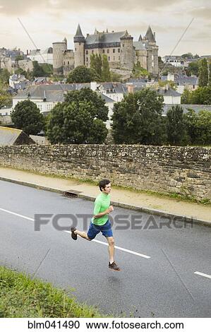 Caucasian man running outdoors View Large Photo Image Stock Image - Caucasian man running outdoors. Fotosearch