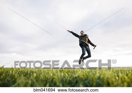 Caucasian man unsheathing sword in field View Large Photo Image Picture - Caucasian man unsheathing sword in field. Fotosearch