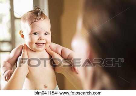 Picture - Caucasian mother bathing baby daughter. Fotosearch