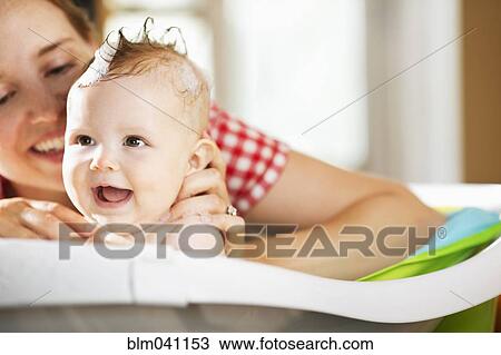 Caucasian mother bathing baby daughter View Large Photo Image Stock Image - Caucasian mother bathing baby daughter. Fotosearch