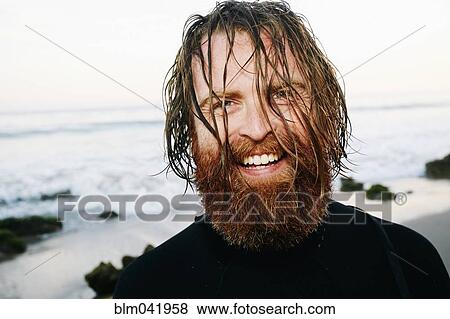 Caucasian surfer with wet hair at beach View Large Photo Image Stock Photo - Caucasian surfer with wet hair at beach. Fotosearch