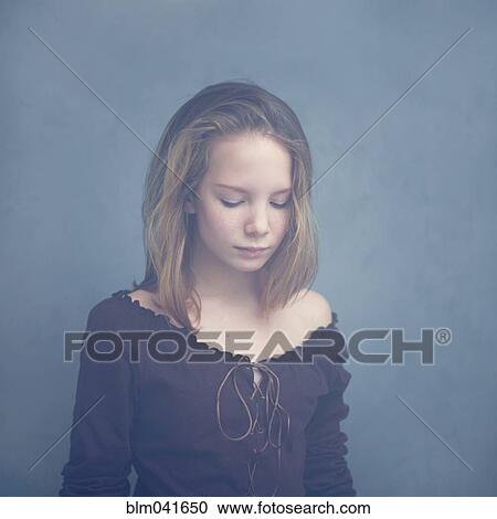 Stock Image - Caucasian teenage girl looking down. Fotosearch