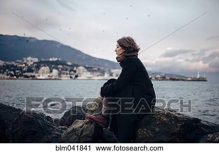 Caucasian woman admiring coastline from rock formation View Large Photo Image Stock Image - Caucasian woman admiring coastline from rock formation. Fotosearch