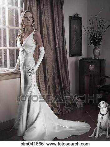 Stock Photograph - Caucasian woman in evening gown with dog. Fotosearch