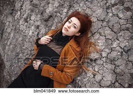 Caucasian woman laying on rock formation View Large Photo Image Stock Photo - Caucasian woman laying on rock formation. Fotosearch