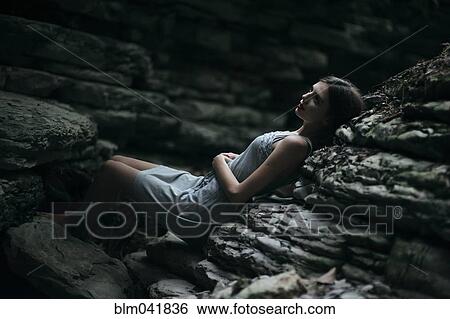 Caucasian woman laying on rock formation View Large Photo Image Stock Photograph - Caucasian woman laying on rock formation. Fotosearch