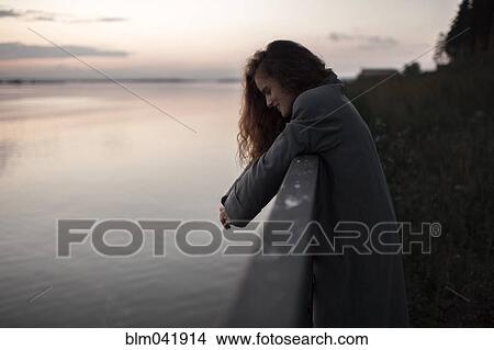 Caucasian woman leaning over river wall View Large Photo Image Picture - Caucasian woman leaning over river wall. Fotosearch