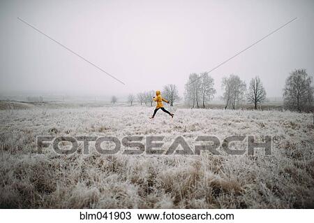 Caucasian woman leaping in snowy field View Large Photo Image Stock Image - Caucasian woman leaping in snowy field. Fotosearch