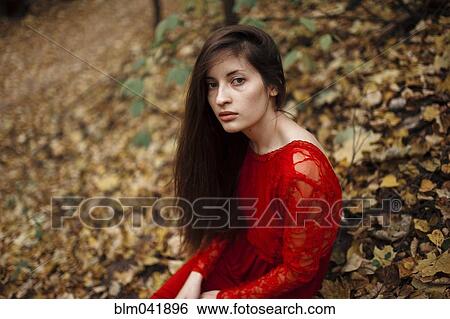 Caucasian woman sitting in autumn leaves View Large Photo Image Stock Photograph - Caucasian woman sitting in autumn leaves. Fotosearch