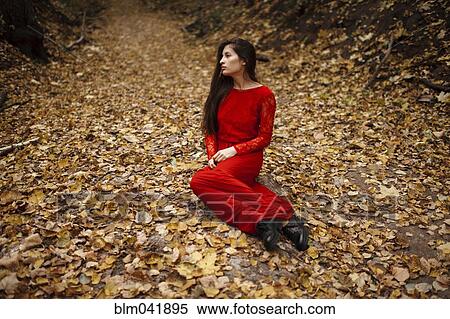 Caucasian woman sitting in autumn leaves View Large Photo Image Stock Photography - Caucasian woman sitting in autumn leaves. Fotosearch