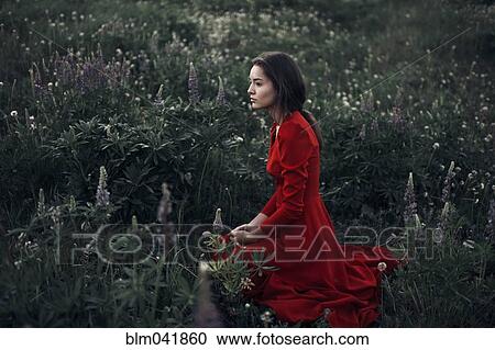 Caucasian woman sitting in field View Large Photo Image Stock Image - Caucasian woman sitting in field. Fotosearch