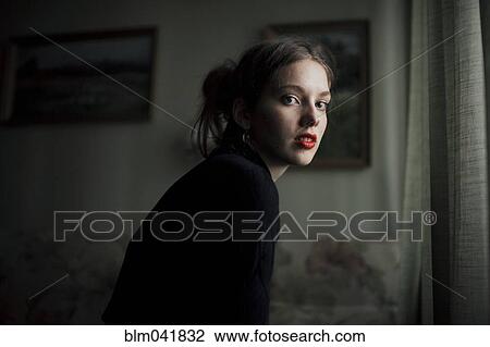 Caucasian woman sitting in living room View Large Photo Image Stock Image - Caucasian woman sitting in living room. Fotosearch