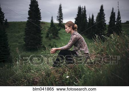 Caucasian woman sitting in remote field View Large Photo Image Stock Photography - Caucasian woman sitting in remote field. Fotosearch