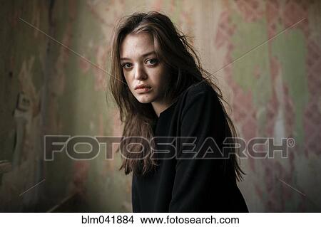 Picture - Caucasian woman sitting indoors. Fotosearch