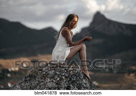 Caucasian woman sitting on remote hilltop View Large Photo Image Stock Photo - Caucasian woman sitting on remote hilltop. Fotosearch