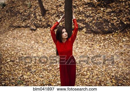 Caucasian woman standing in autumn leaves View Large Photo Image Stock Photo - Caucasian woman standing in autumn leaves. Fotosearch