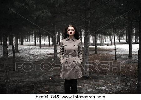 Stock Photography - Caucasian woman standing in snowy forest. Fotosearch